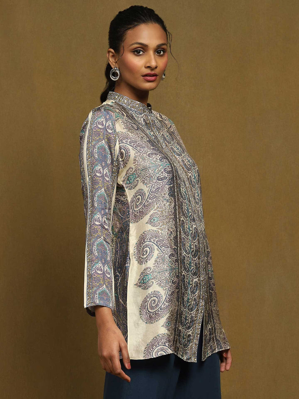 Woman wearing a patterned against a brown background