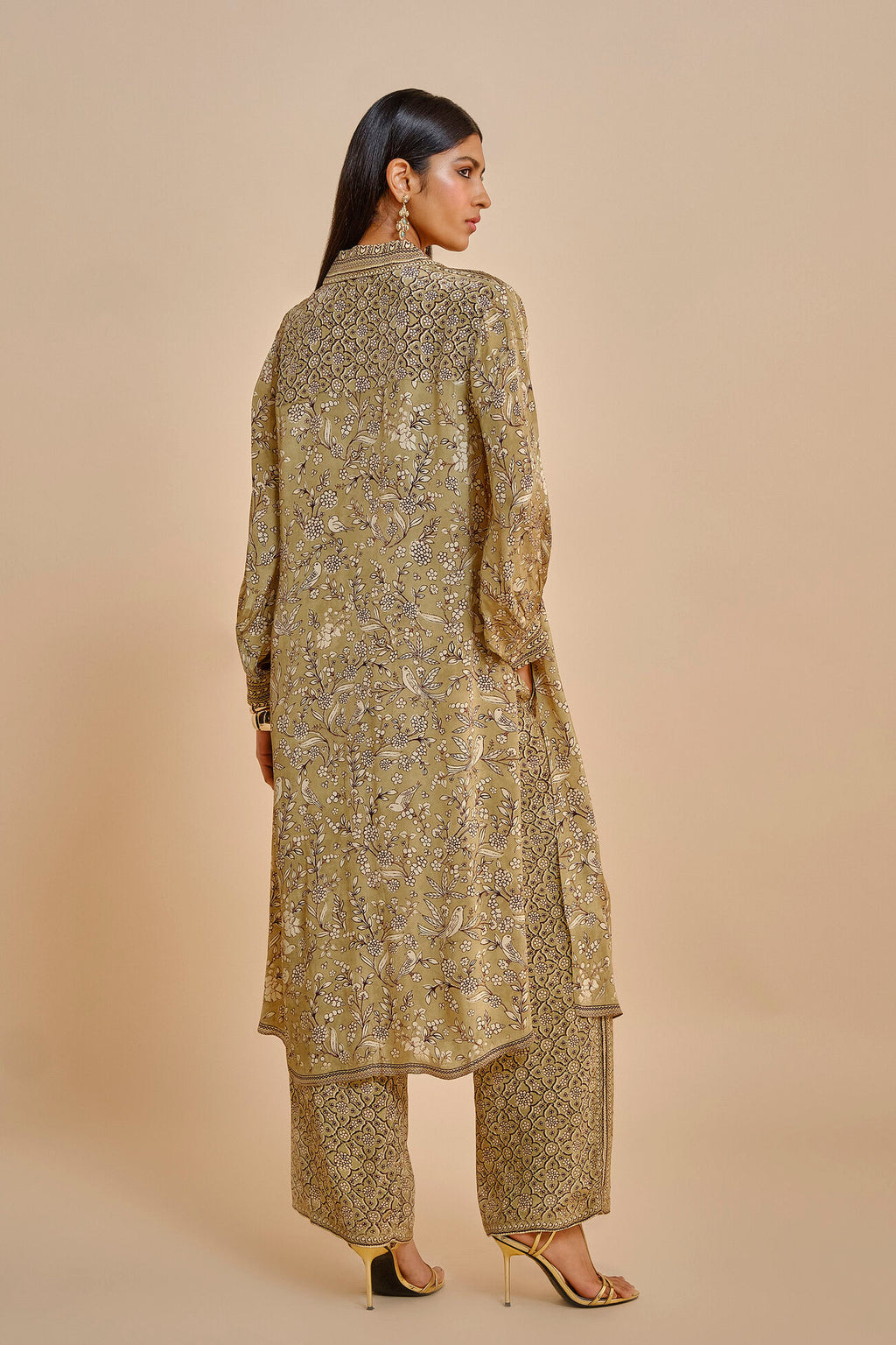 Woman wearing a traditional outfit with a beige background