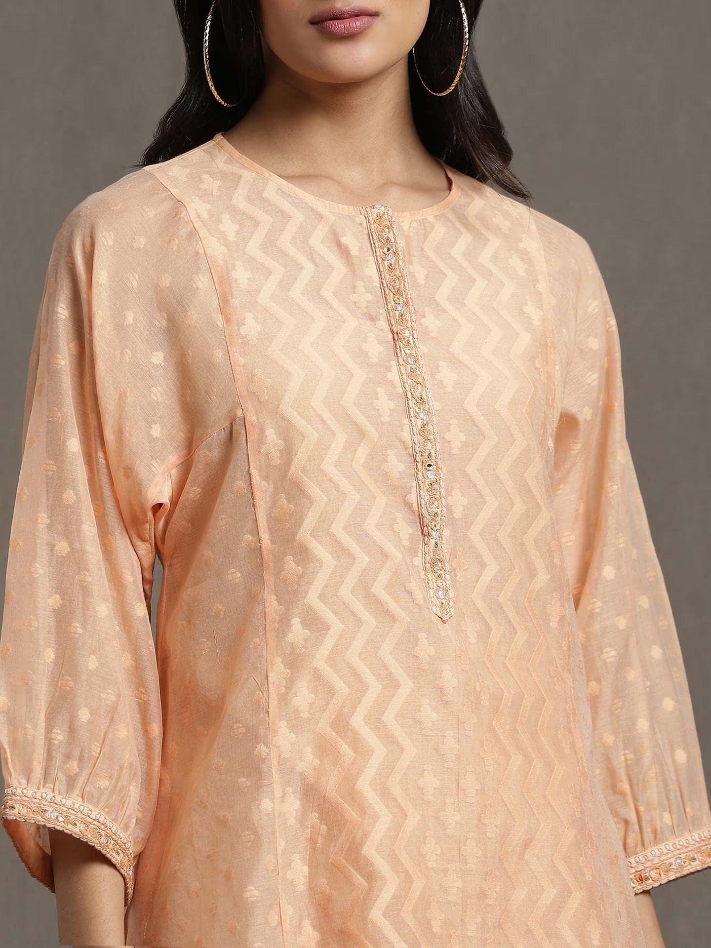 Beige embroidered kurta worn by a model against a neutral background
