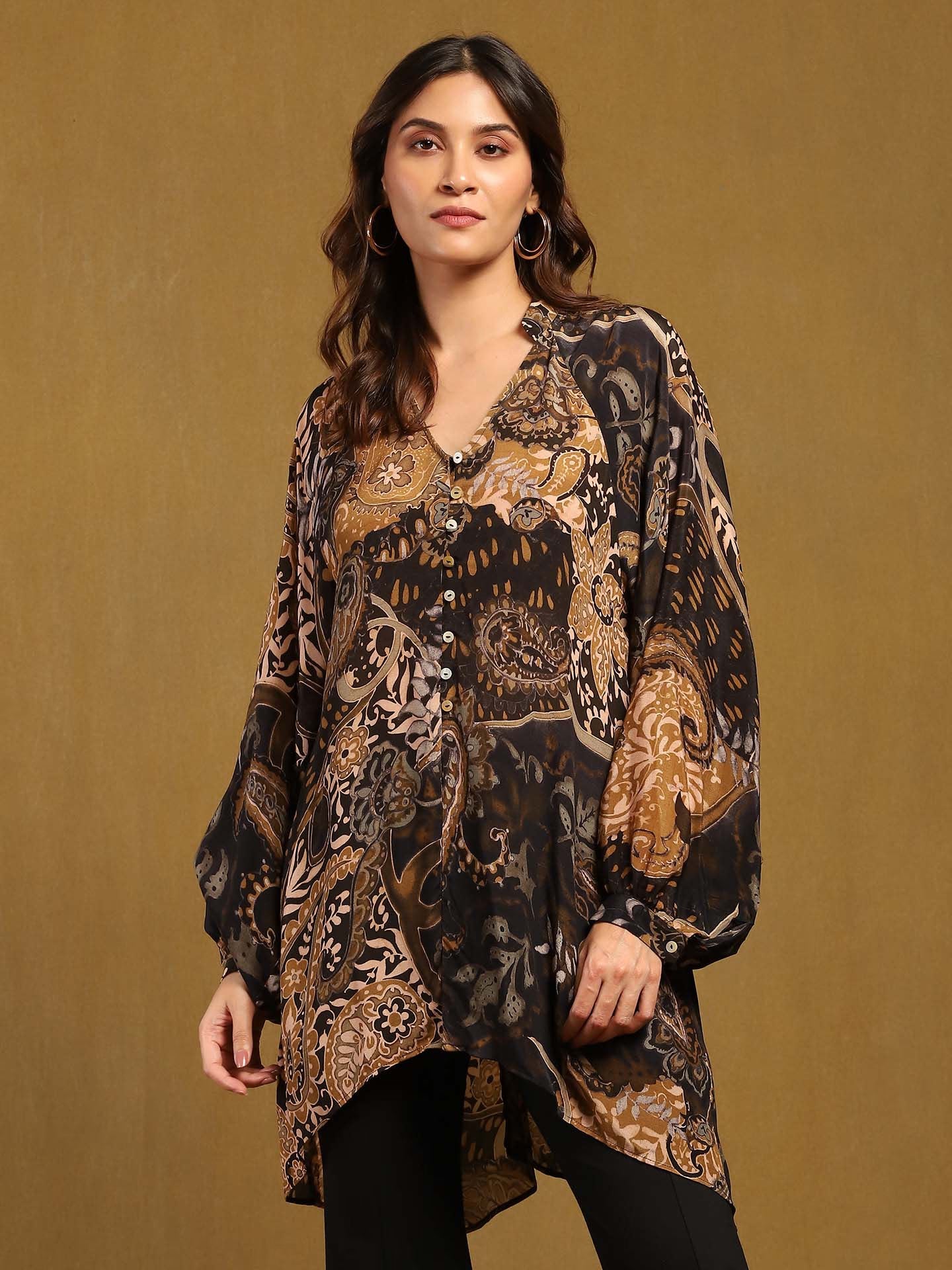 Woman wearing a patterned kurta against a brown background