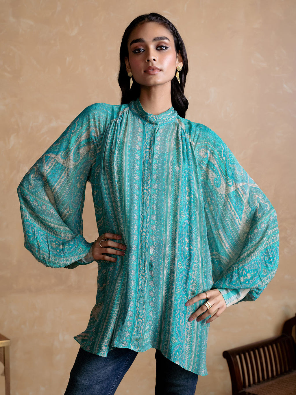 Woman wearing a Blue patterned Kurta against a beige background