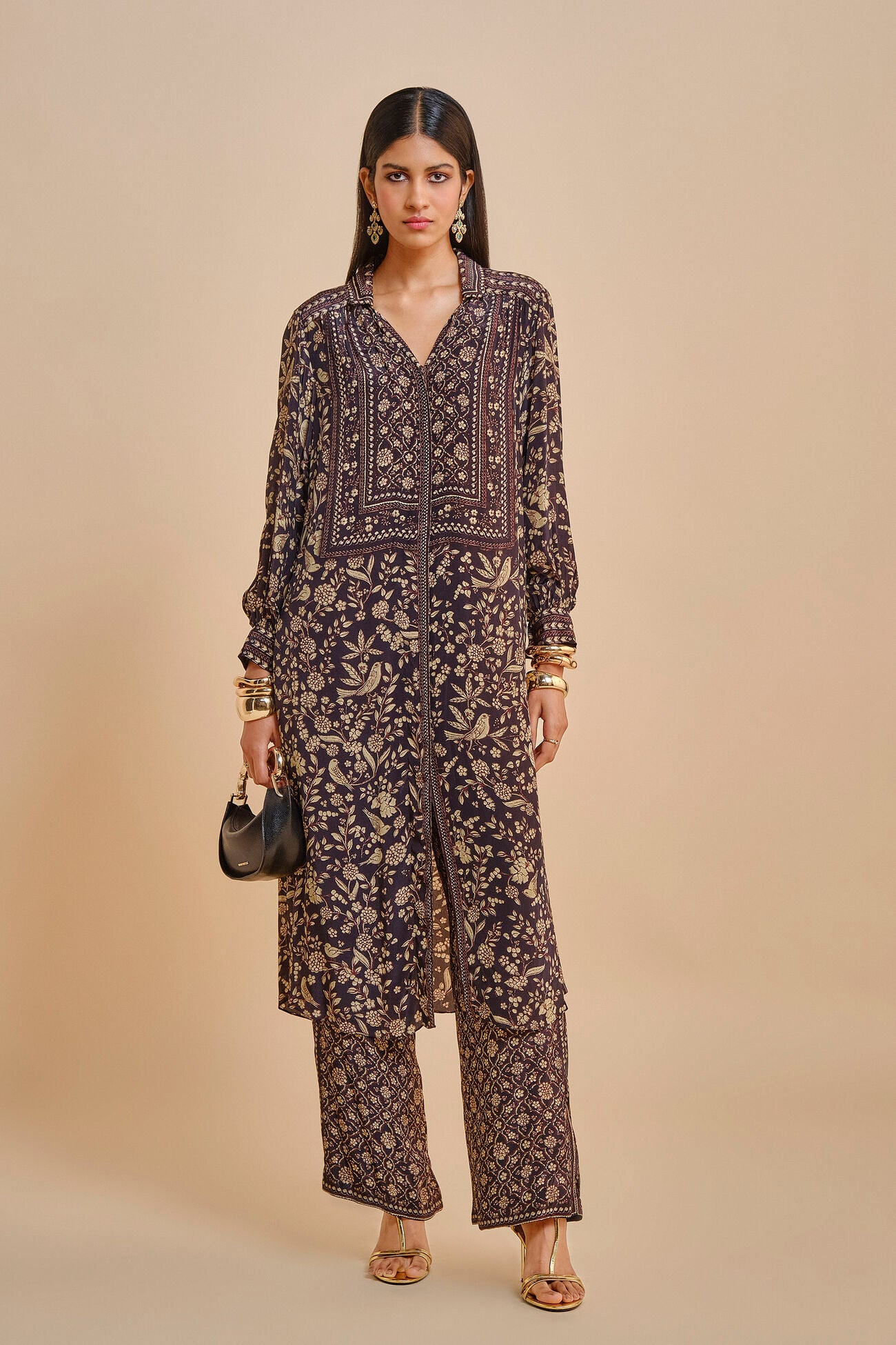 Woman wearing a patterned outfit with a beige background