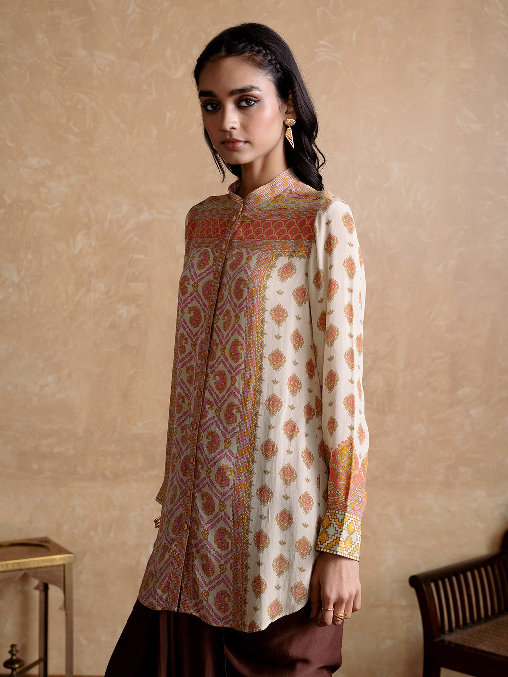 Woman wearing a patterned kurta with a beige background