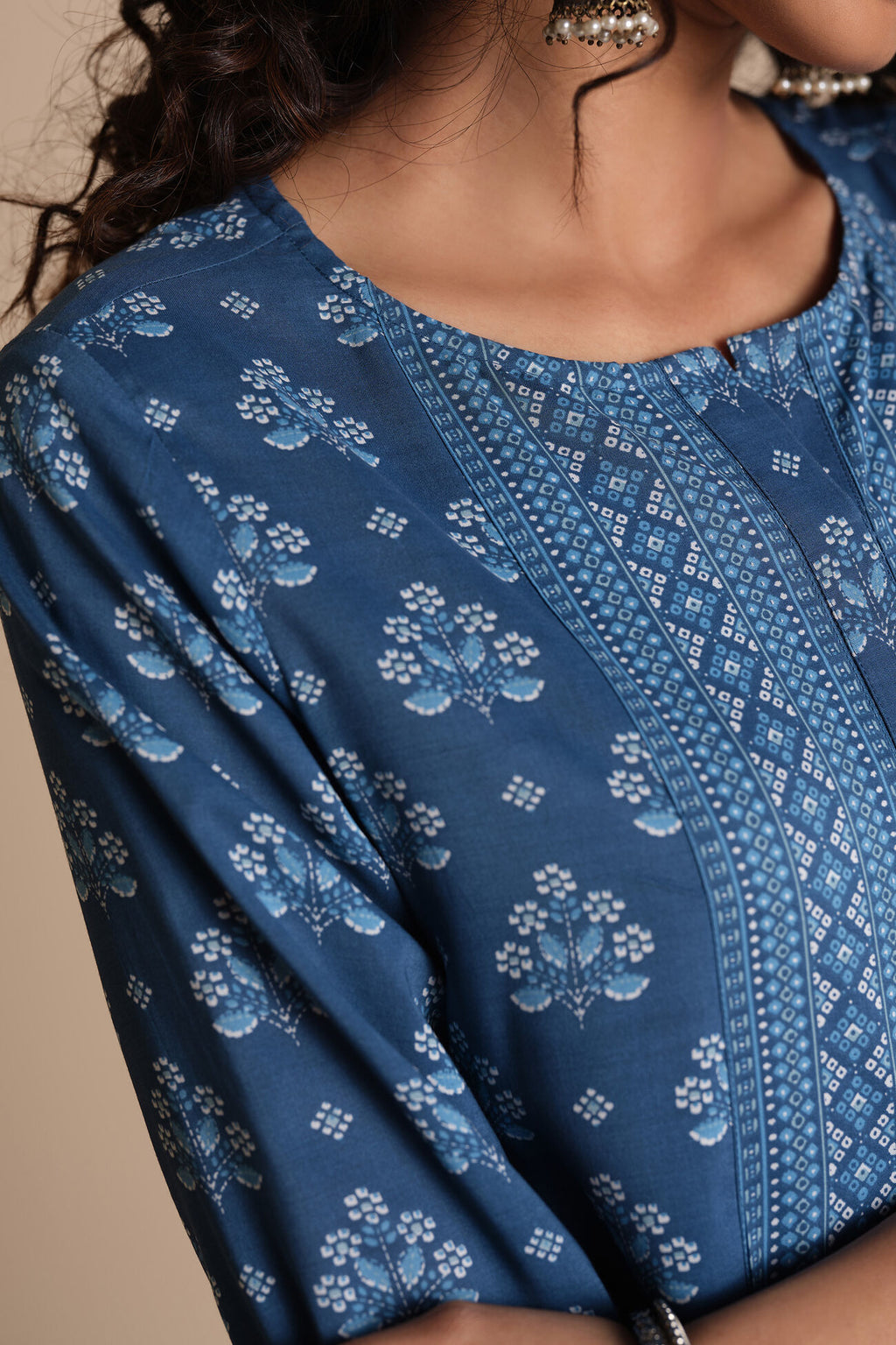 Close-up of a blue patterned garment with a neutral background