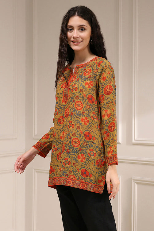 Woman wearing a patterned top with a neutral background