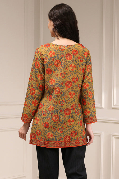 Woman wearing a patterned top with a neutral background