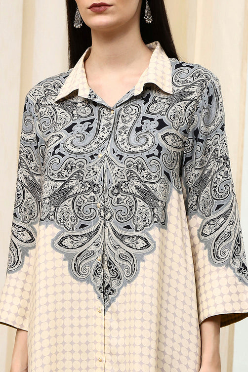 Woman wearing a black and white patterned shirt over a beige checkered dress.