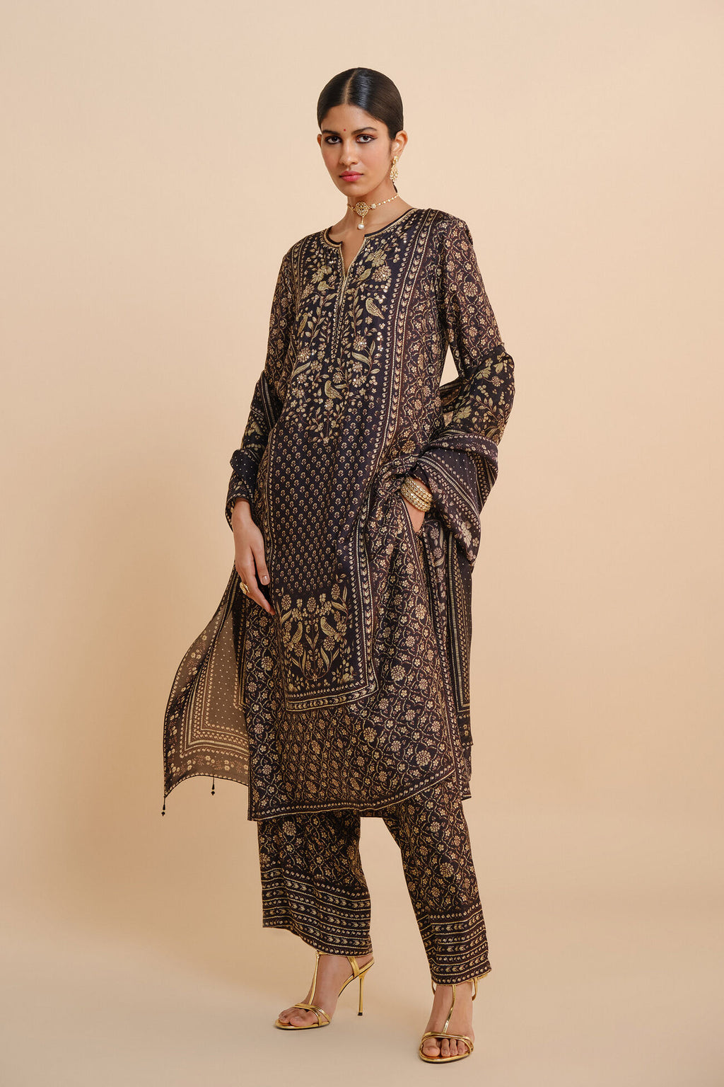 Woman wearing a patterned outfit on a beige background