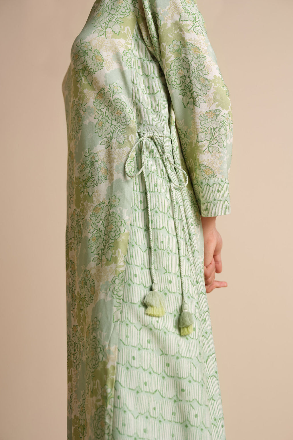 Green patterned dress on a beige background
