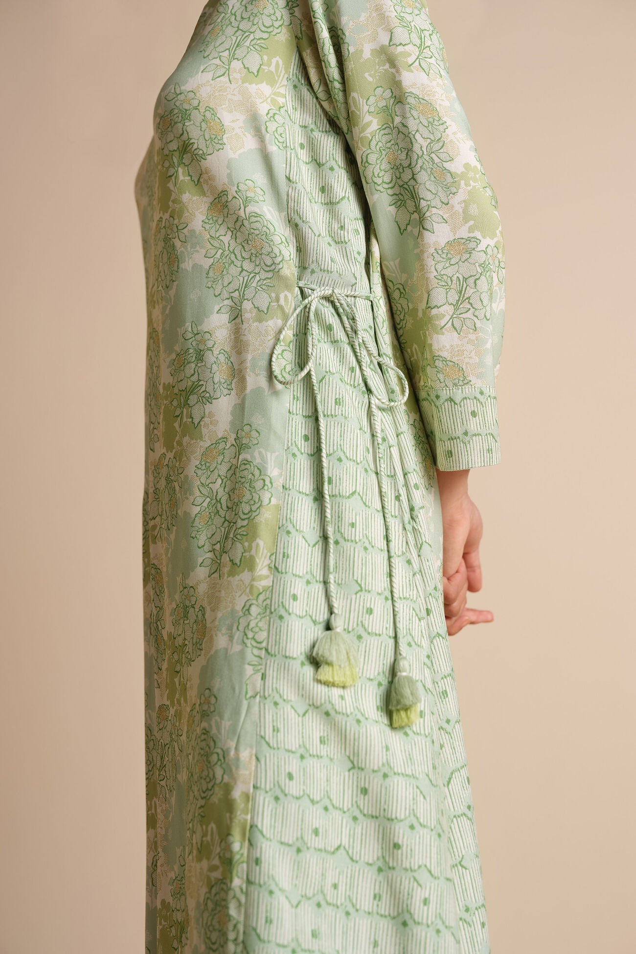Green patterned dress on a beige background